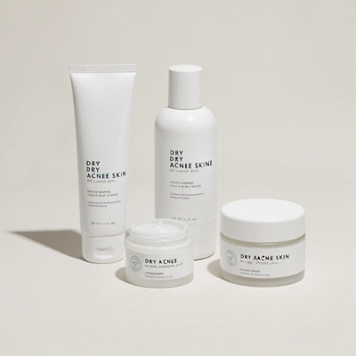 Skincare products for dry acne-prone skin, clean packaging, minimalist