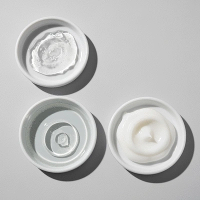 Close-up of various skincare ingredients in small dishes, representing salicylic acid, hyaluronic acid, and ceramides, on a clean, light background, no text, no words, no typography, clean image